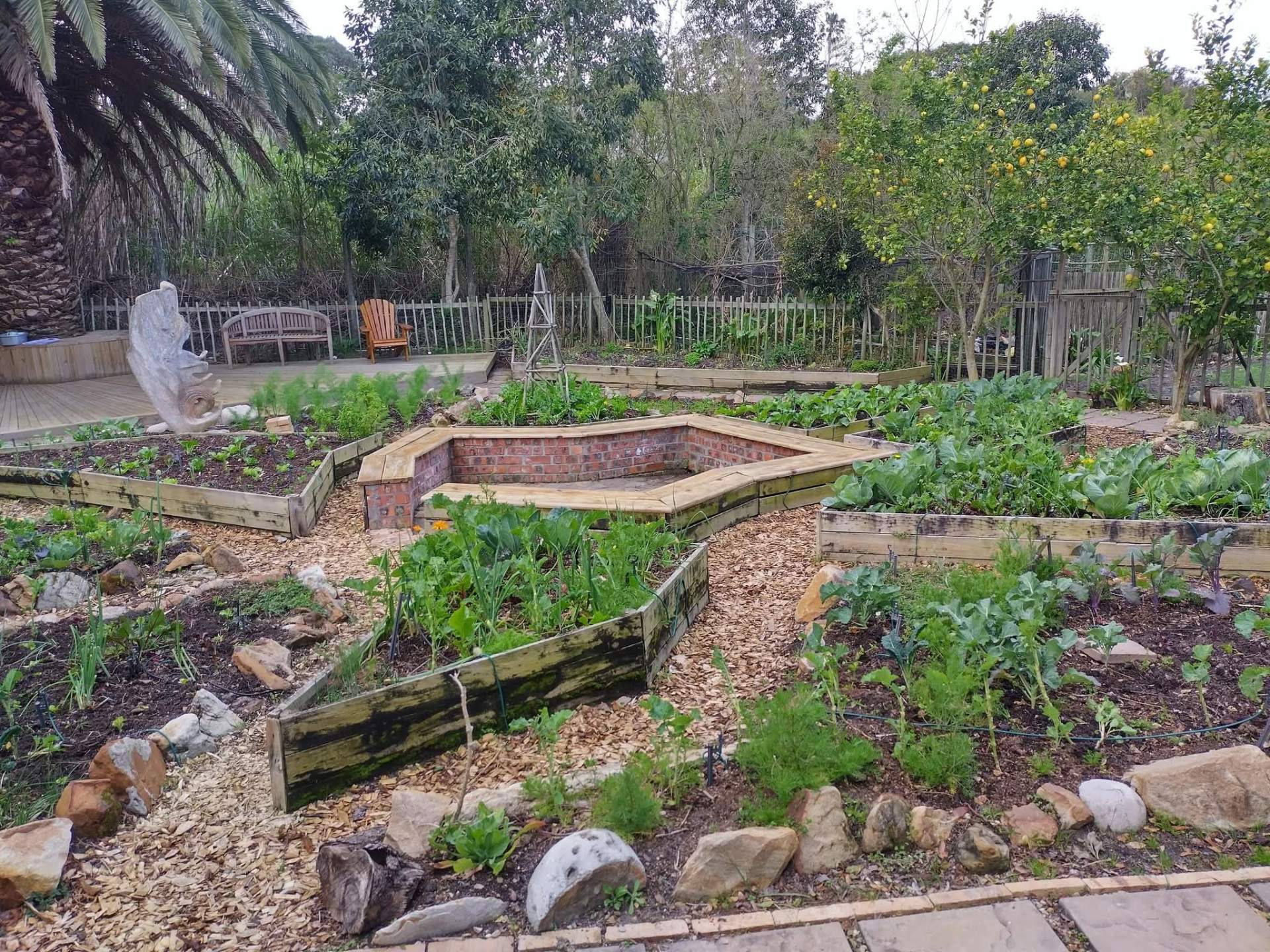 Brick-edged formal herb centrepiece garden bed