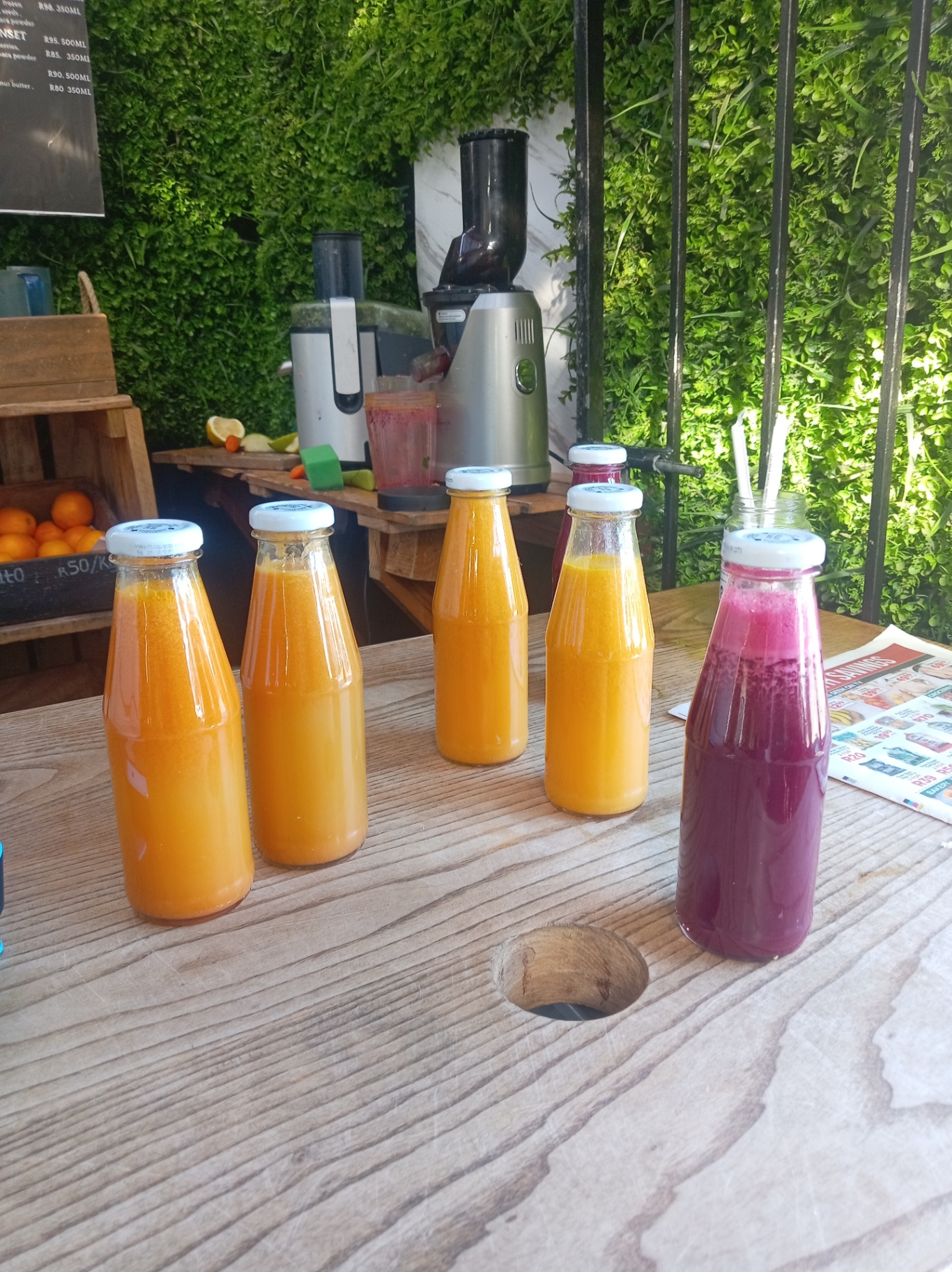 Bottled cold-pressed juices lined up on the bar
