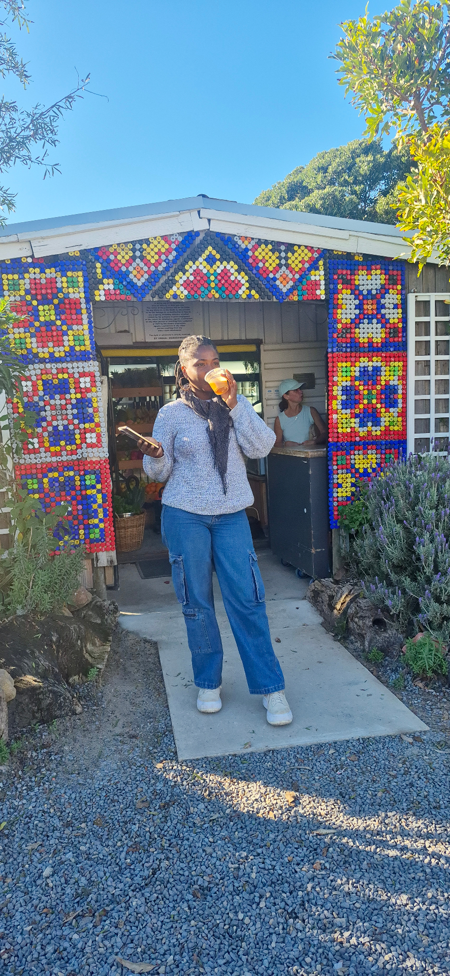 Customer sipping fresh juice outside the bottle-cap juice bar