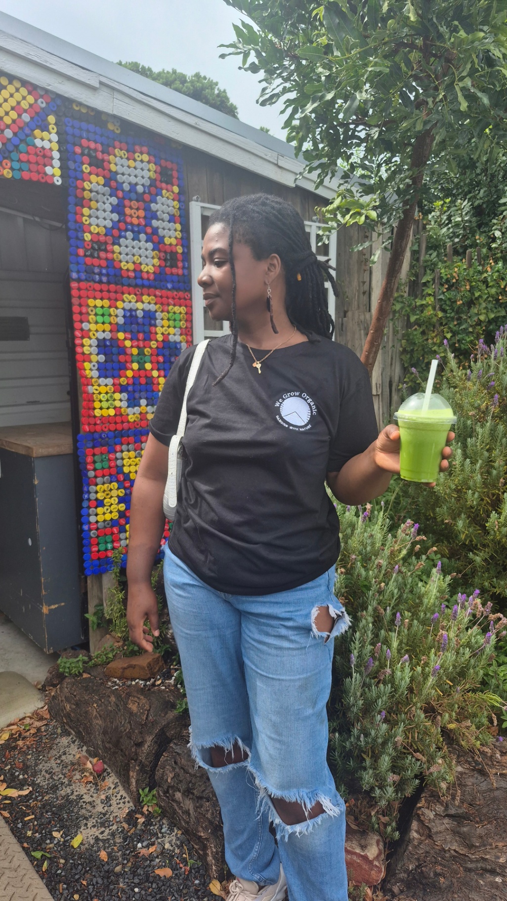 Customer with green juice by the bottle-cap juice bar wall