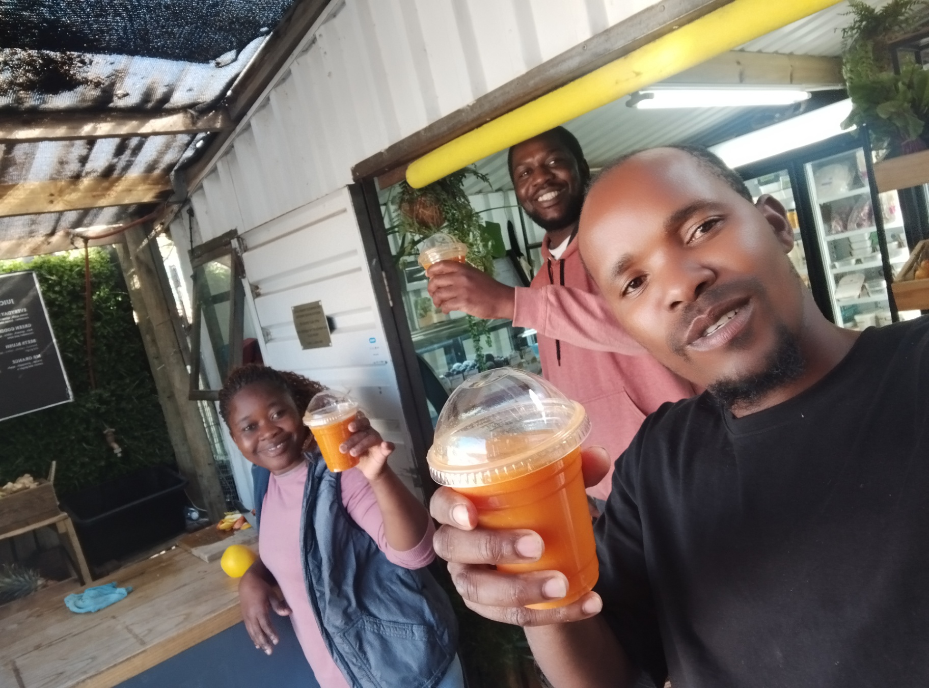 Friends sharing fresh juice at the bar