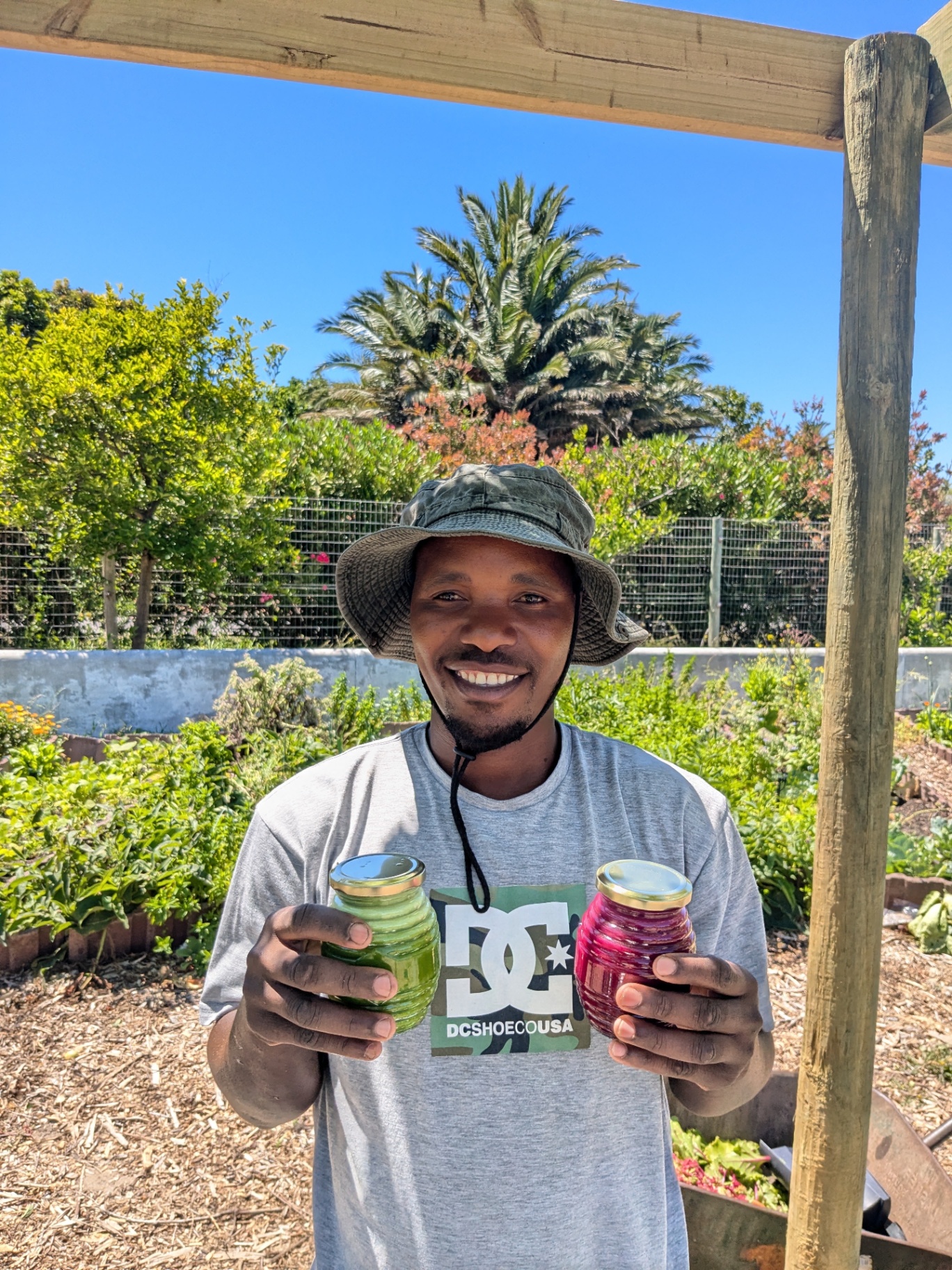 Farmer holding jars of cold-pressed green and beet juice