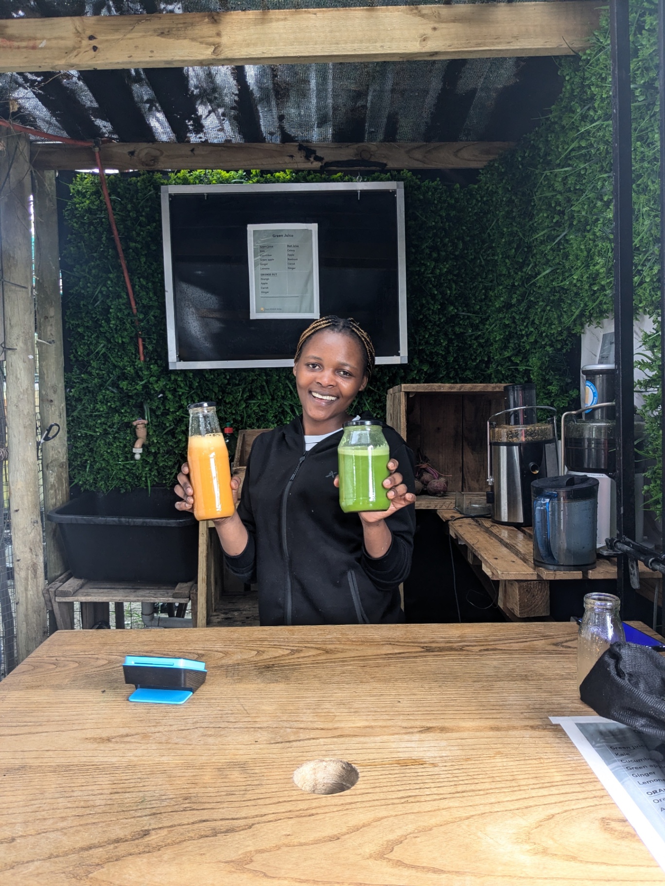 Green and orange juice bottles fresh off the press